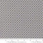 Fabric swatch with a diamond pattern with a ruler for scale