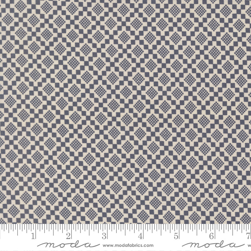 Fabric swatch with a diamond pattern with a ruler for scale