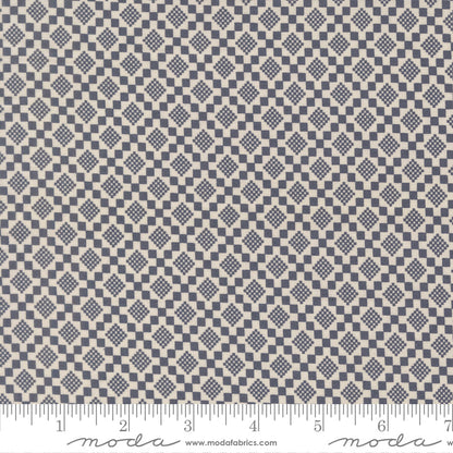 Fabric swatch with a diamond pattern with a ruler for scale