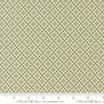 Fabric swatch with a diamond pattern with a ruler for scale