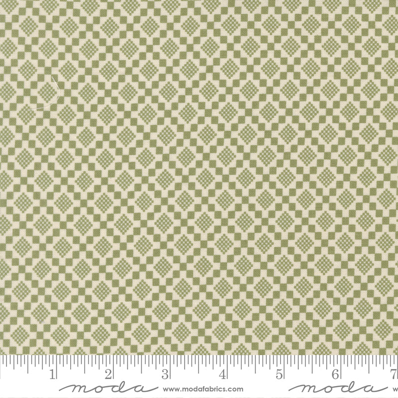 Fabric swatch with a diamond pattern with a ruler for scale