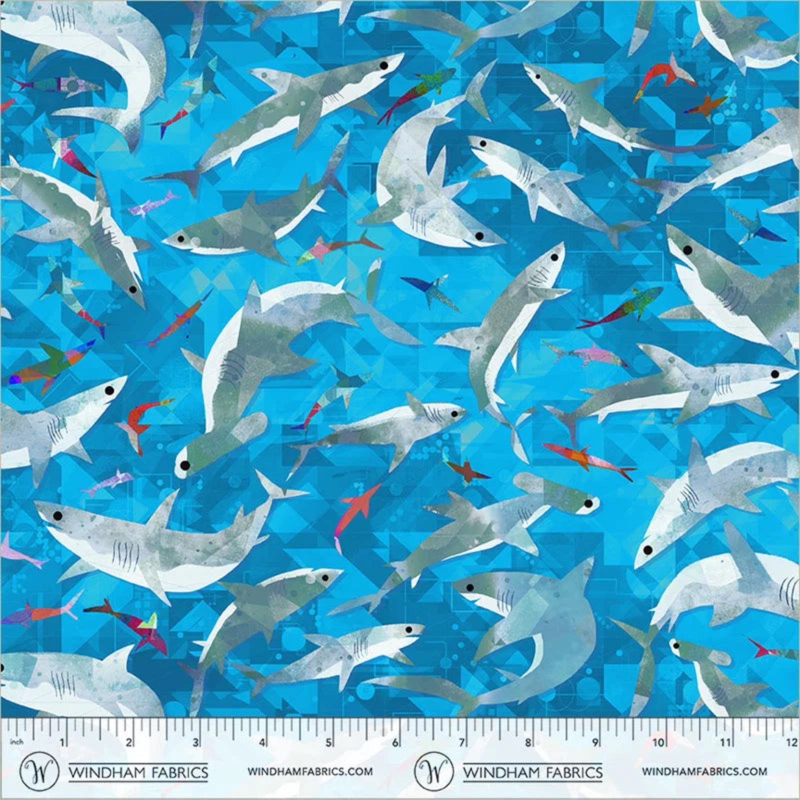 A repeating pattern of swimming sharks in blue water, shown as a fabric print with a ruler along the bottom edge displaying Windham Fabrics branding and measurements.