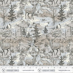 A fabric pattern featuring a detailed woodland scene with deer, elk, wolves, mountains, trees, and a stream in black and gray line art on a warm beige background. A ruler at the bottom shows the scale of the print with Windham Fabrics branding.