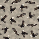 A repeating pattern of flying bald eagles on a warm taupe-gray background. The eagles are shown in flight from multiple angles, with dark brown and black wings, white heads, and white-tipped tails.