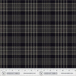A close-up fabric swatch showing a black and gray plaid pattern with a ruler scale along the bottom edge displaying the brand Windham Fabrics.