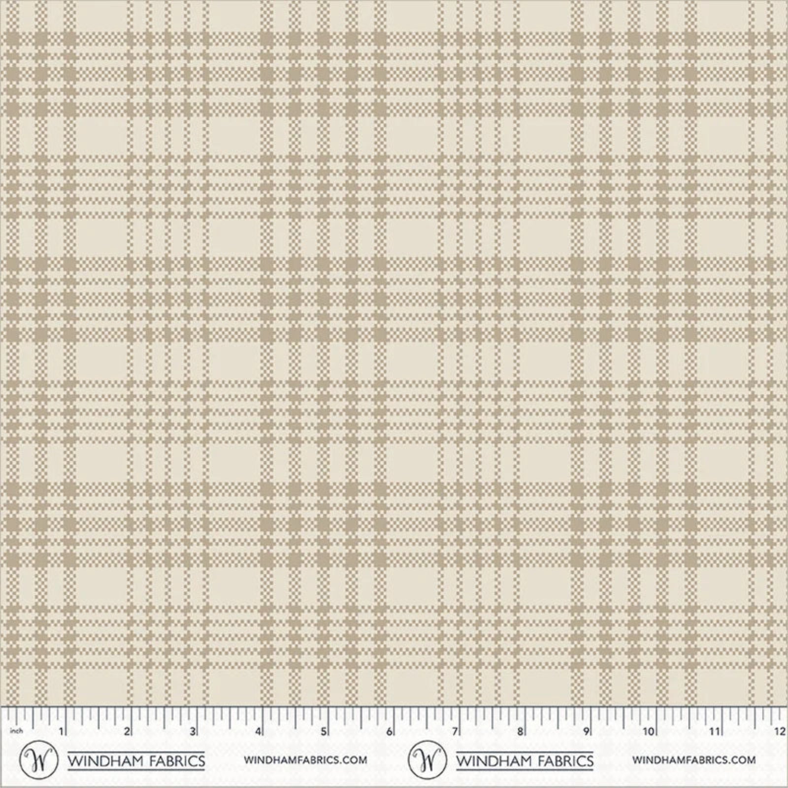 A close-up of a plaid fabric pattern with warm beige and taupe lines on an off-white background, shown with a measuring ruler along the bottom edge from Windham Fabrics.