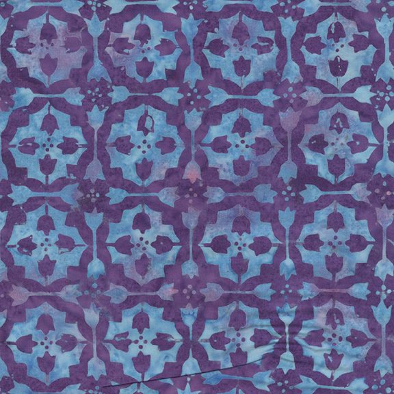A close-up of a patterned fabric or wallpaper featuring a repeating geometric tile design in shades of purple and light blue.