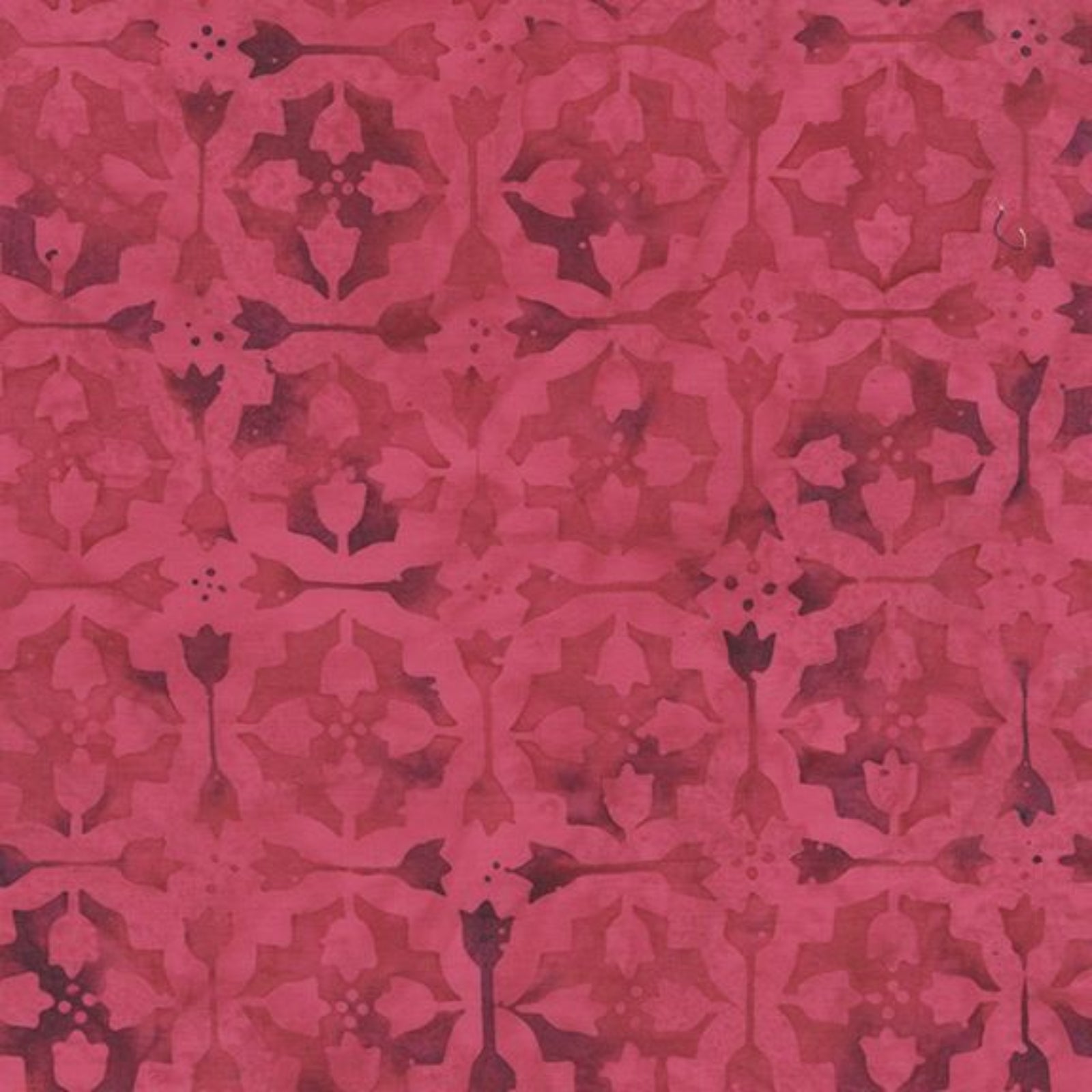 A close-up of a repeating ornamental pattern in shades of pink and magenta, resembling a damask or floral motif.