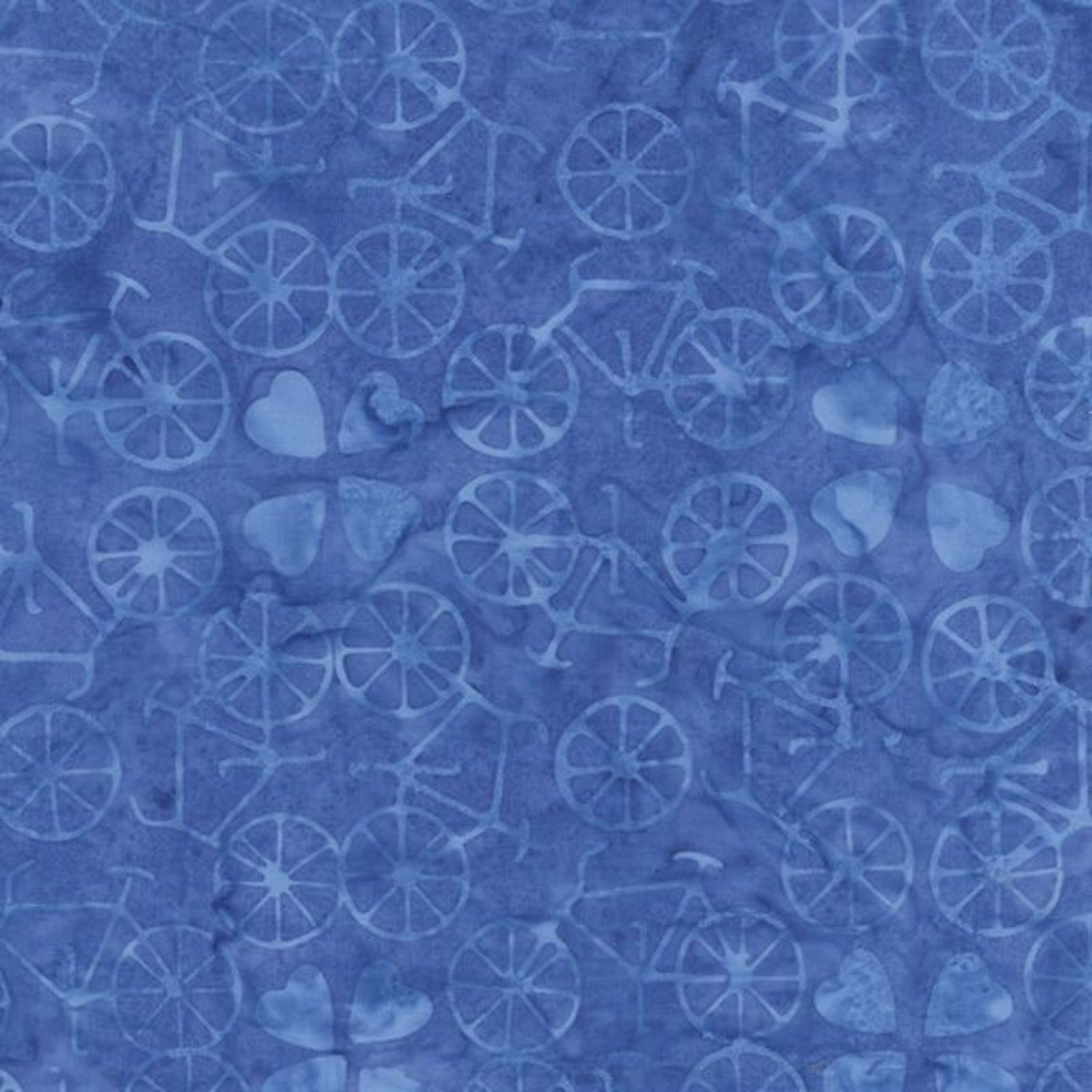 Blue batik fabric with a repeating pattern of bicycles, hearts, and abstract shapes in lighter blue shades.