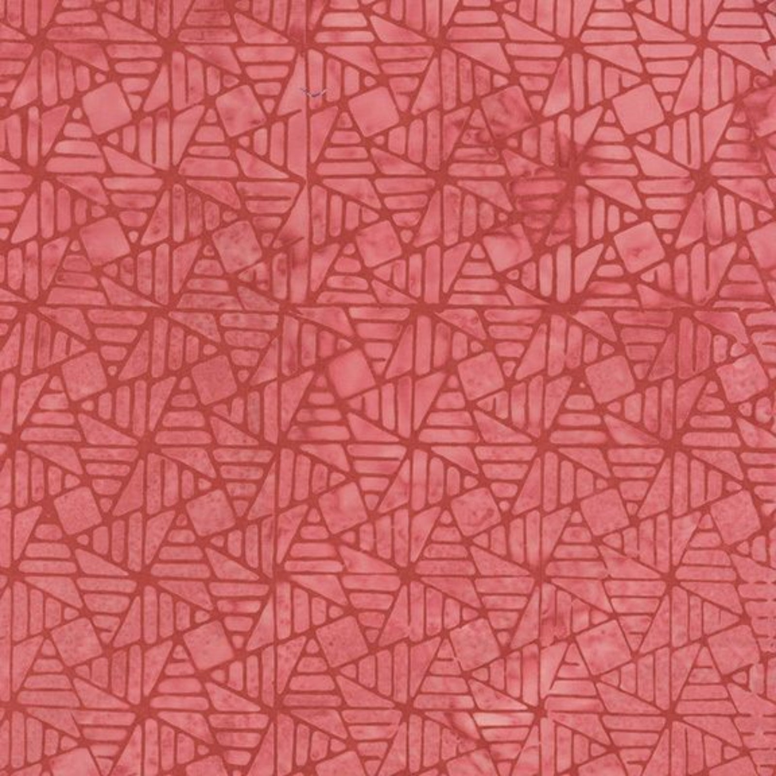 A close-up of a coral pink fabric with a repeating geometric pattern of interlocking triangles and lines.