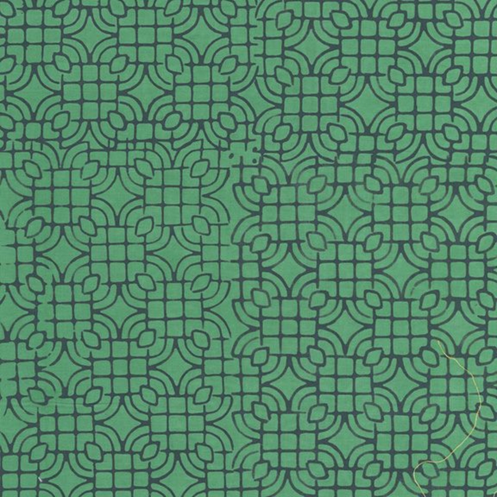 A close-up of a repeating geometric pattern in muted green with dark green outlines, filling the entire frame.