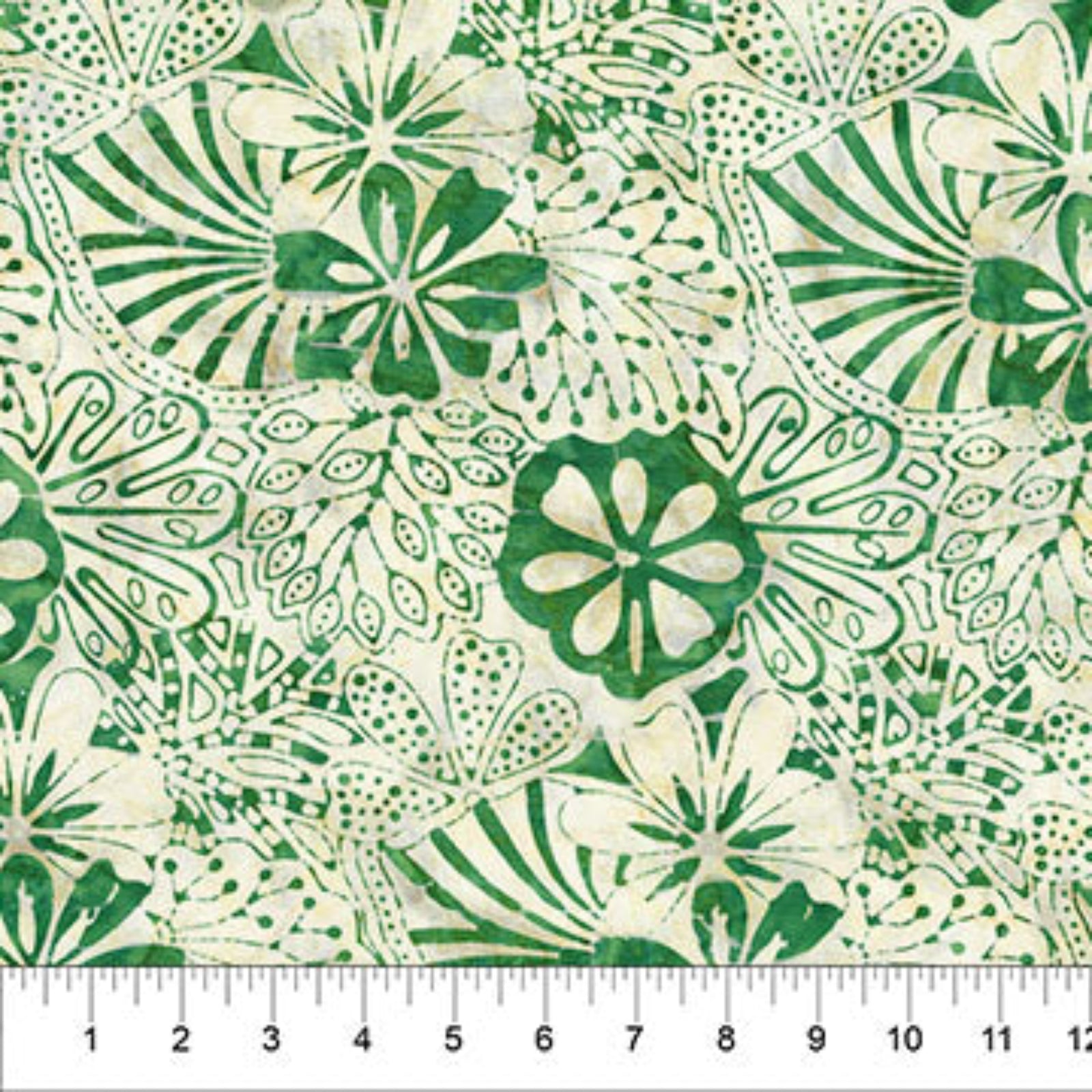 A close-up of a fabric pattern featuring green hand-drawn style floral and leaf motifs on a warm cream background, with a ruler at the bottom showing scale.