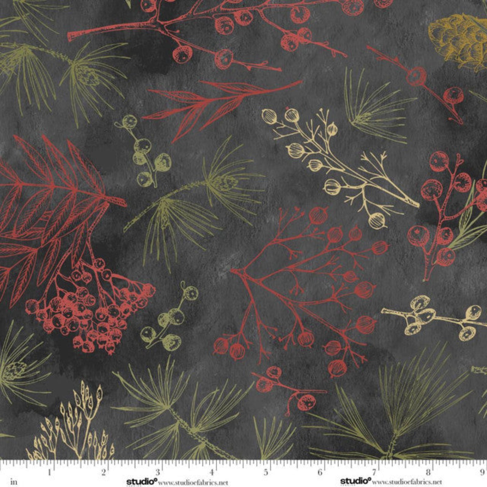 A close-up of a fabric pattern featuring red and olive green botanical illustrations, including pine needles and berry clusters, on a dark charcoal gray background. A white measurement ruler is visible along the bottom edge.