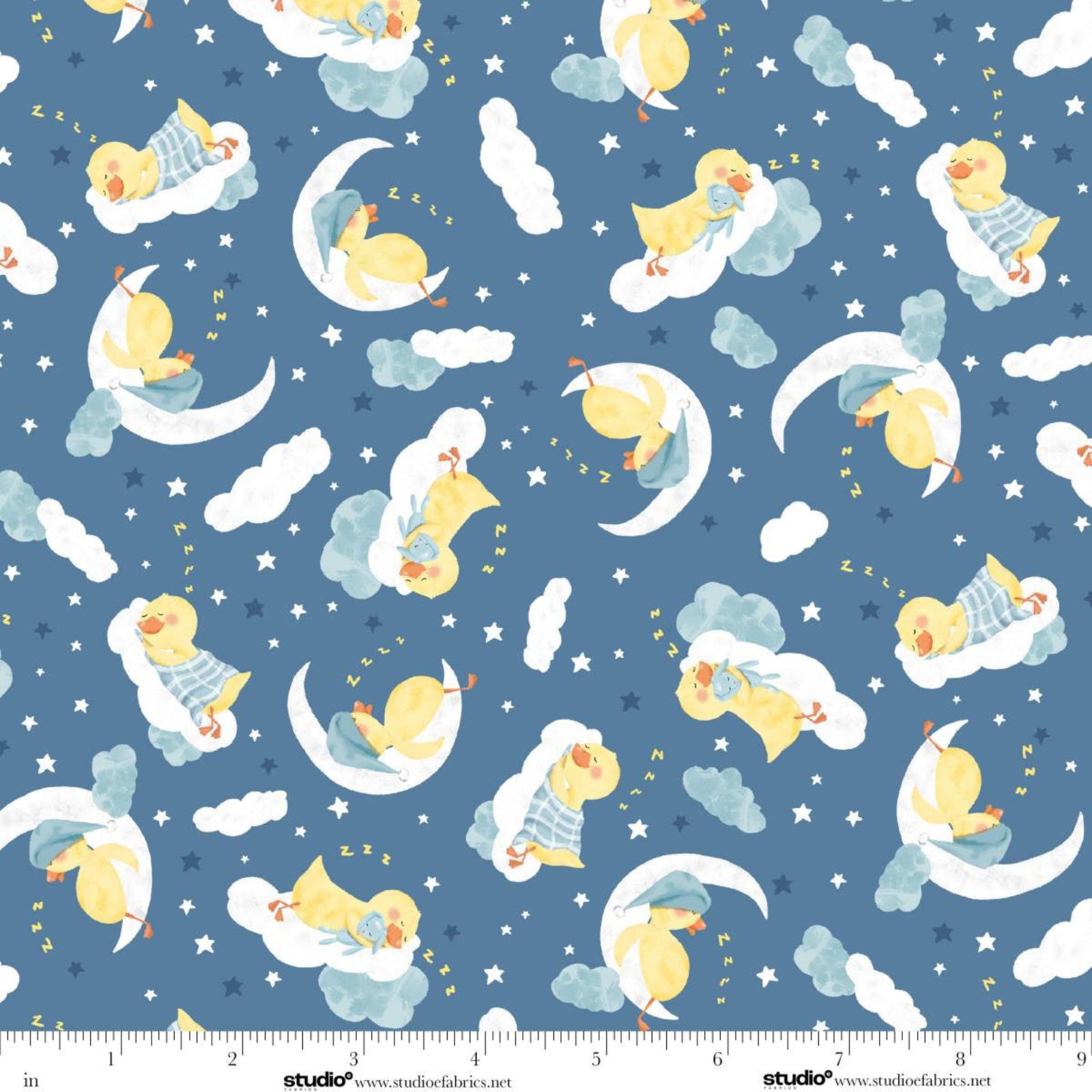 A repeating fabric pattern featuring yellow sleeping ducks on crescent moons and in clouds against a dusty blue background, with small white stars. A white ruler strip with 'studiowww.