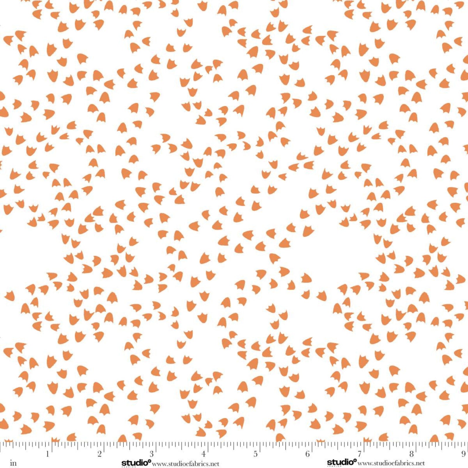White fabric with a repeating pattern of small orange duck foot prints, shown with a ruler along the bottom edge for scale.