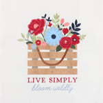 A decorative graphic print featuring a wooden crate filled with colorful flowers and leaves, with the text 'LIVE SIMPLY' in red and 'bloom wildly' in light blue script below, on a plain light background.