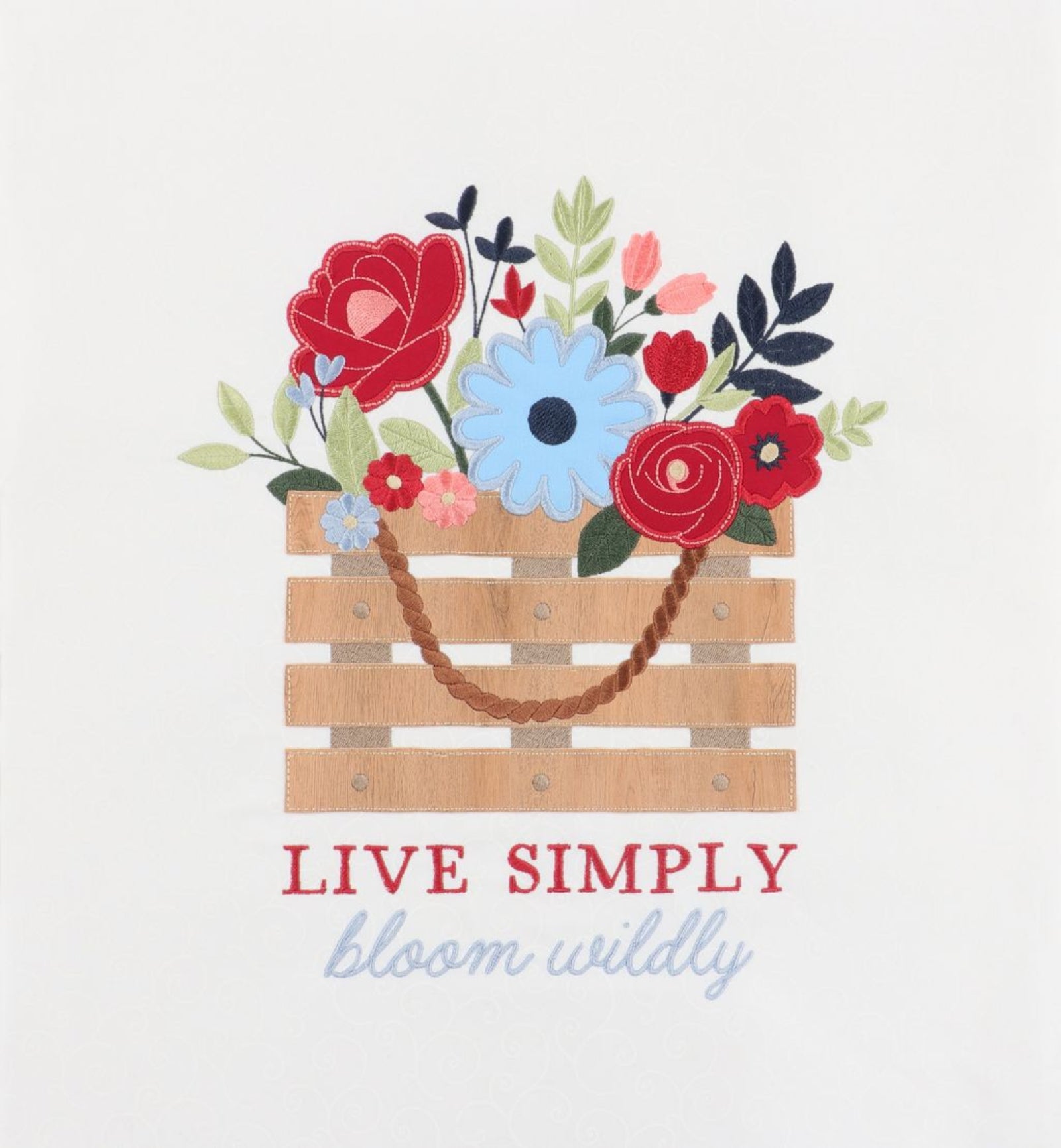 A decorative graphic print featuring a wooden crate filled with colorful flowers and leaves, with the text 'LIVE SIMPLY' in red and 'bloom wildly' in light blue script below, on a plain light background.