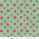 Pattern of red bows with gold centers on a green background