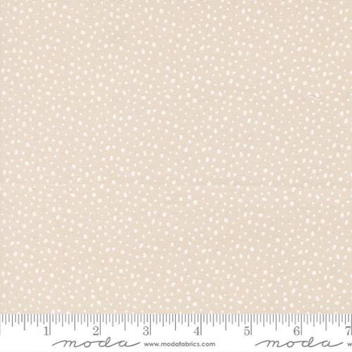 Beige fabric with small white polka dots.