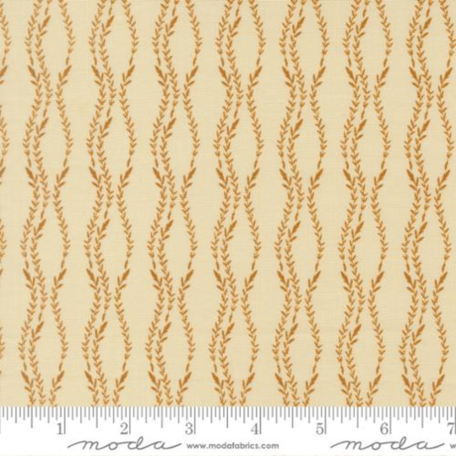 Beige fabric with a repeating vertical wavy pattern of tan leafy stems, shown with a white ruler along the bottom edge for scale. The brand name 'moda' is printed on the ruler.