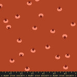 Pattern of small pink persimmons on a brown background with a ruler at the bottom.