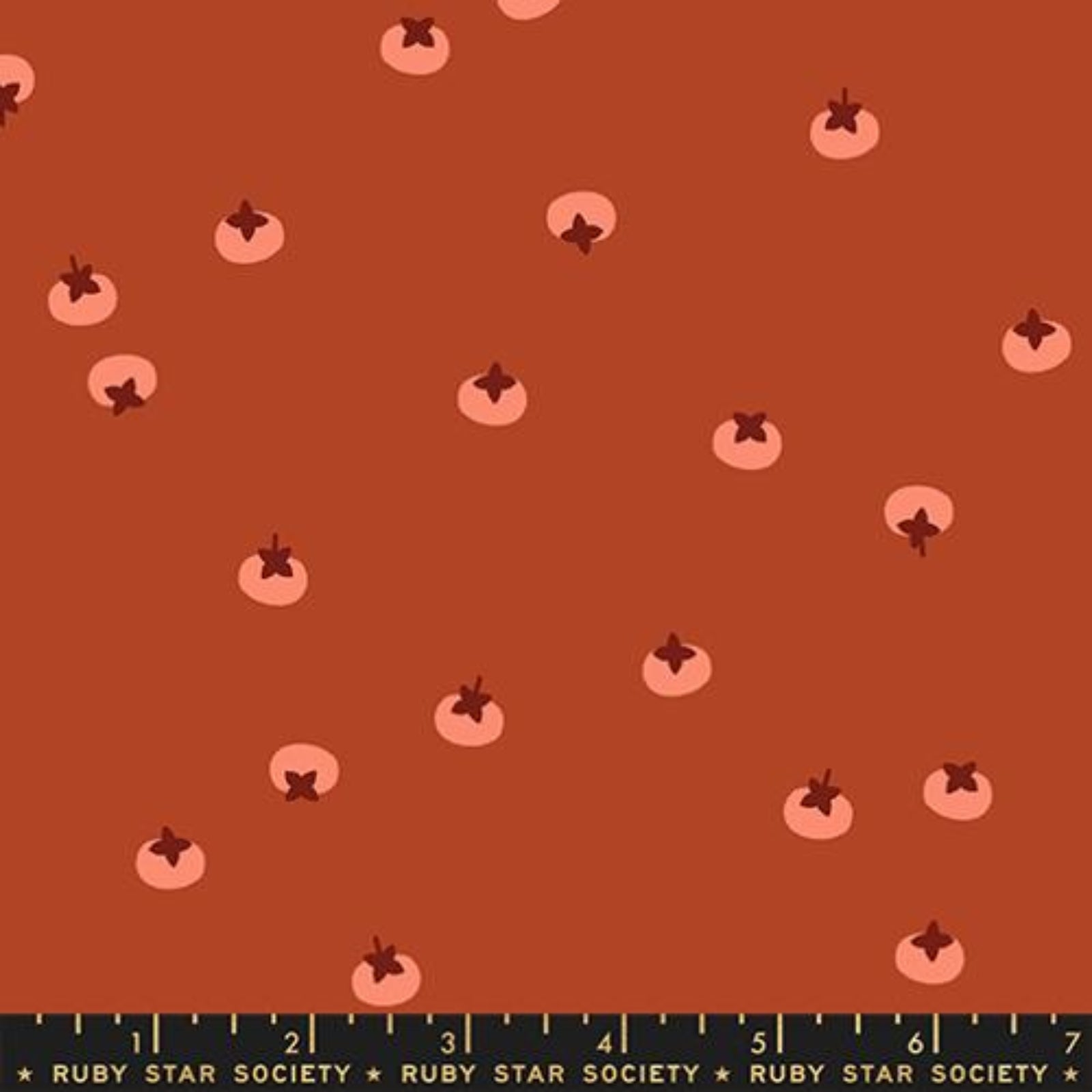 Pattern of small pink persimmons on a brown background with a ruler at the bottom.