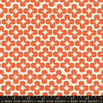 Patterned fabric with orange geometric design on a white background, Ruby Star Society label at the bottom.
