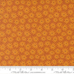 Patterned fabric with orange flowers on a matching background