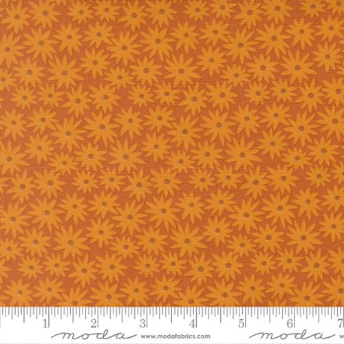 Patterned fabric with orange flowers on a matching background