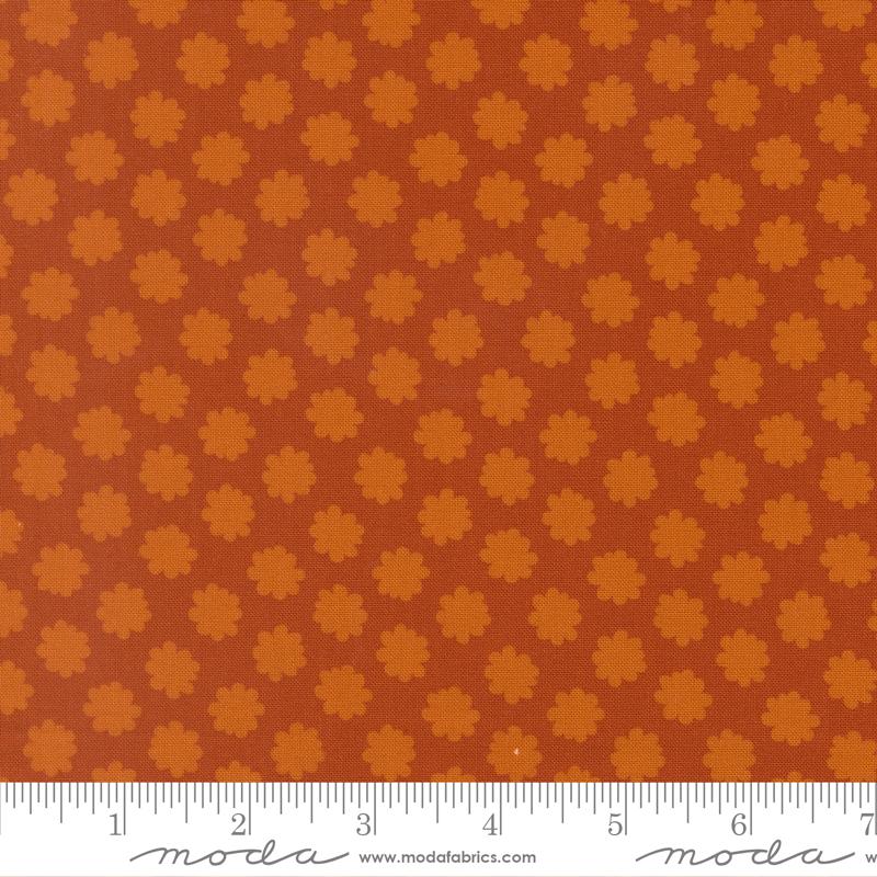 Fabric with small flower pattern on a brown background