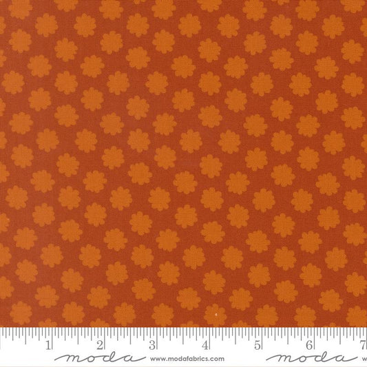 Fabric with small flower pattern on a brown background