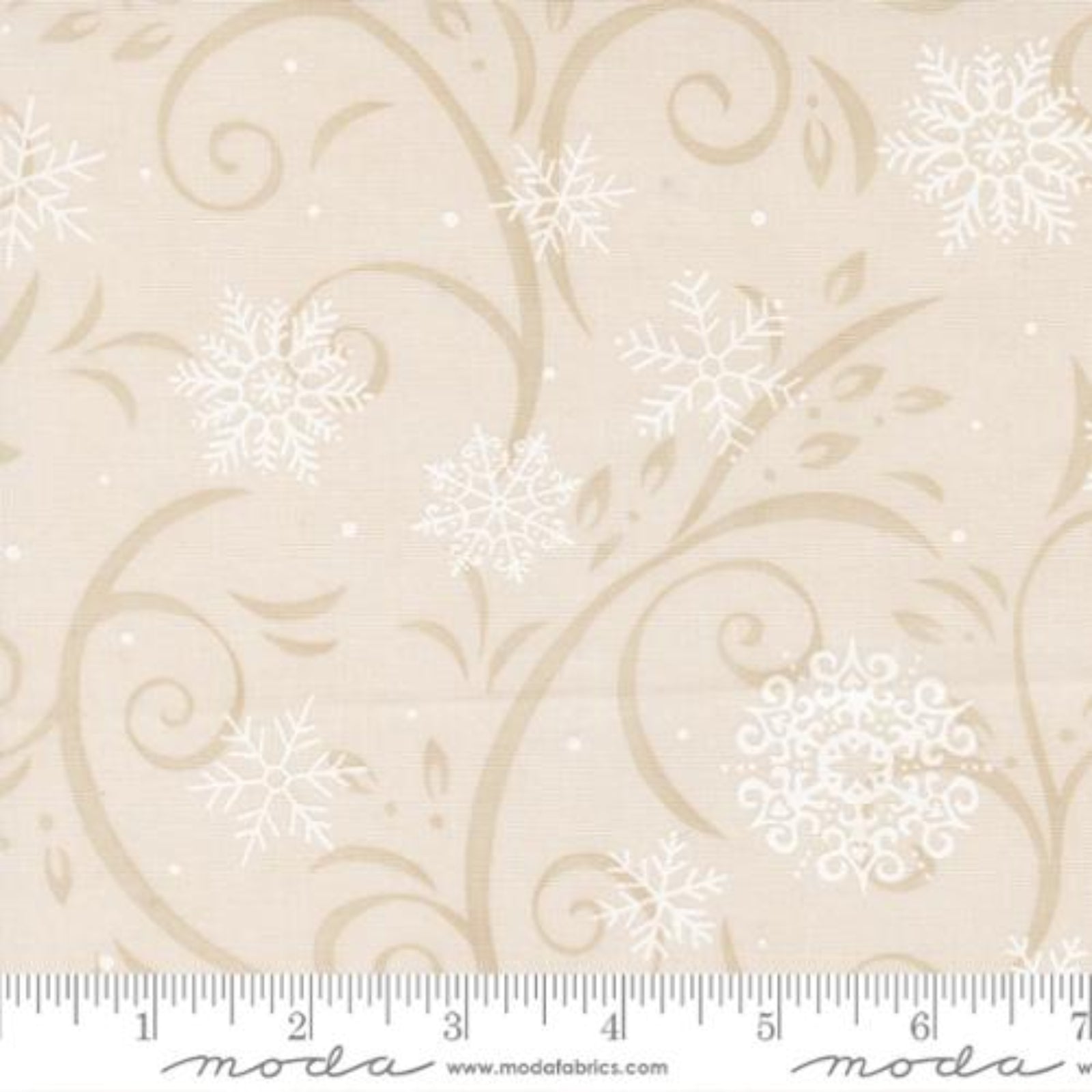 Beige fabric with white snowflakes and swirl patterns, featuring a ruler for scale.