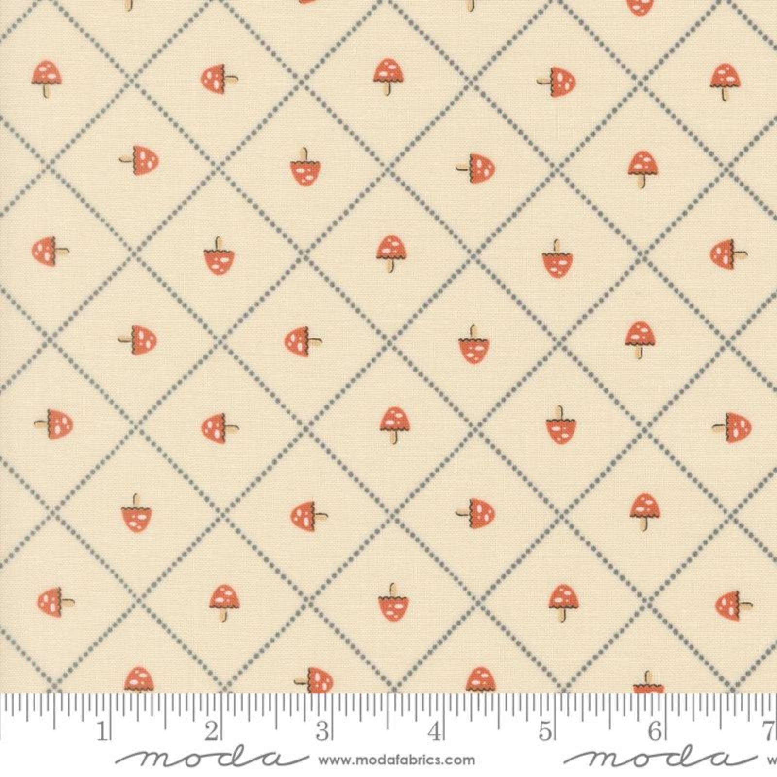 Fabric pattern with small red mushrooms on a beige background, featuring Moda label.
