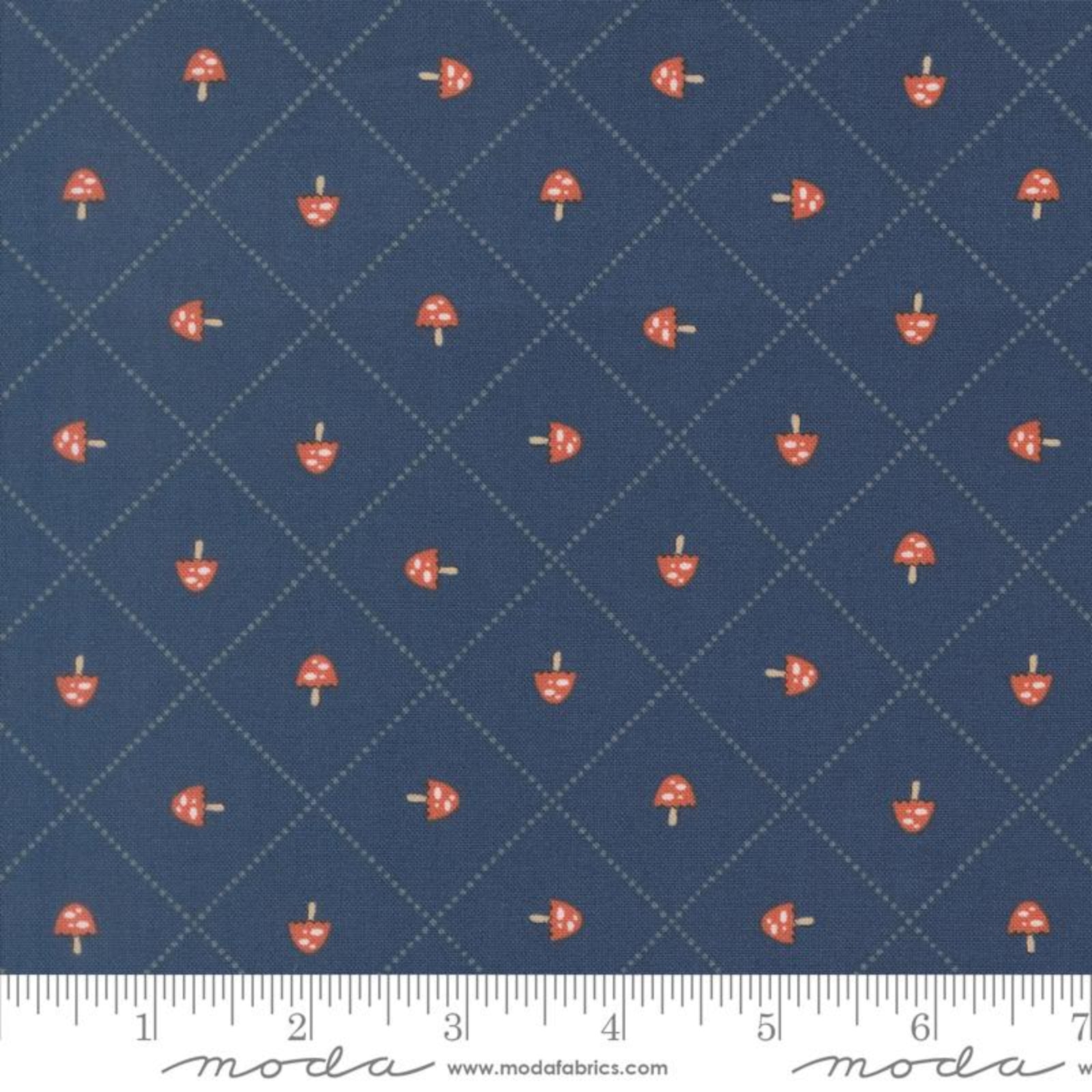 Fabric with red mushroom pattern on a blue background, featuring Moda label.