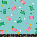Colorful spool pattern on a blue background with a ruler at the bottom.