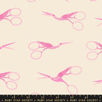 Fabric pattern with pink stork scissors on a beige background, featuring Ruby Star Society label.