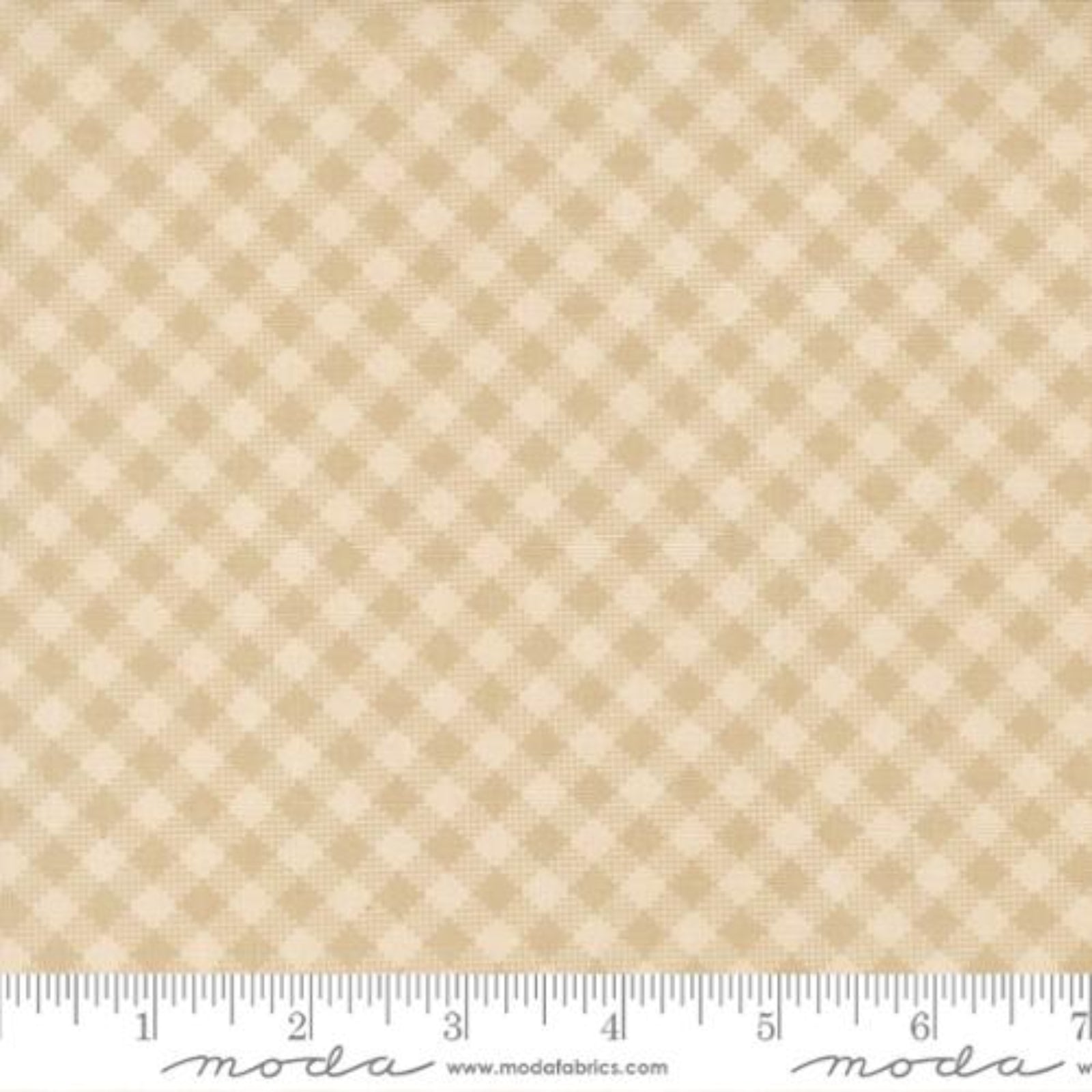Beige fabric with a diamond pattern and a ruler at the bottom for scale.