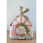 Decorative house-shaped box with rabbit design on a wooden surface