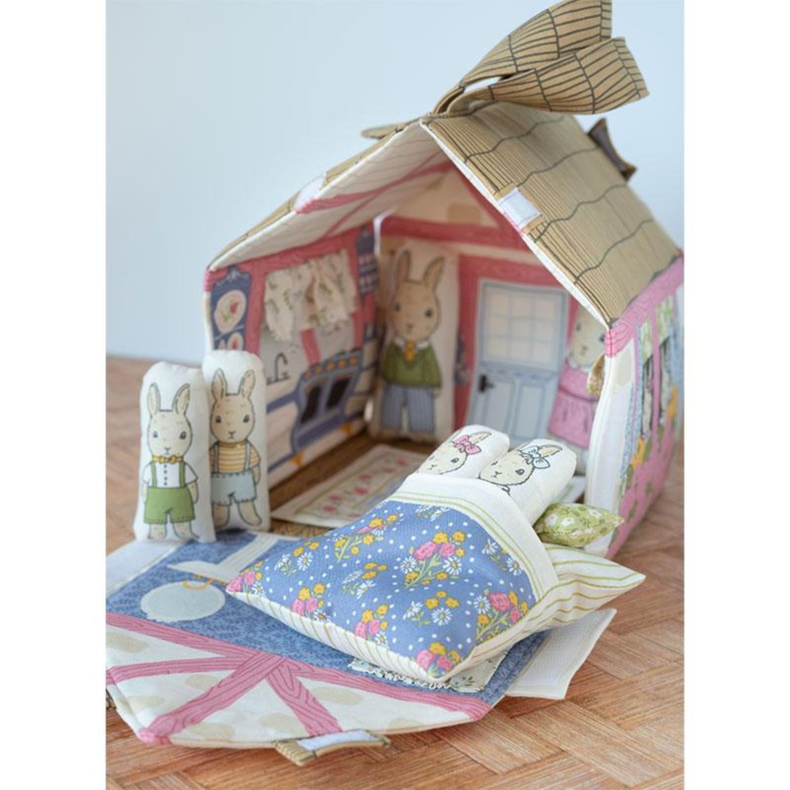 Children's playhouse with rabbit-themed decorations on a wooden floor.