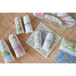 Decorative pillows with rabbit illustrations and text on a wooden floor.