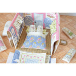 Children's quilt with cartoon characters on a wooden floor