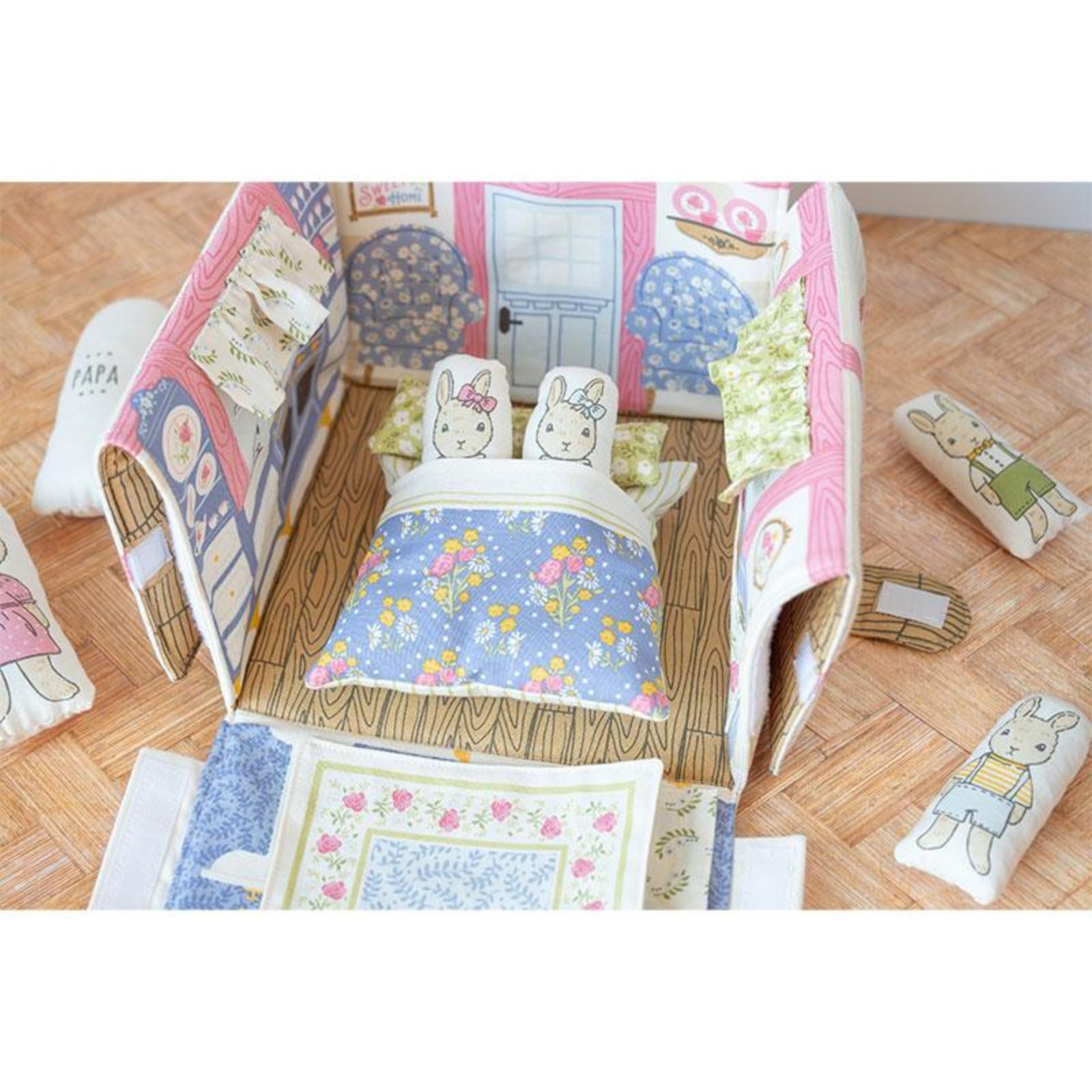 Children's quilt with cartoon characters on a wooden floor