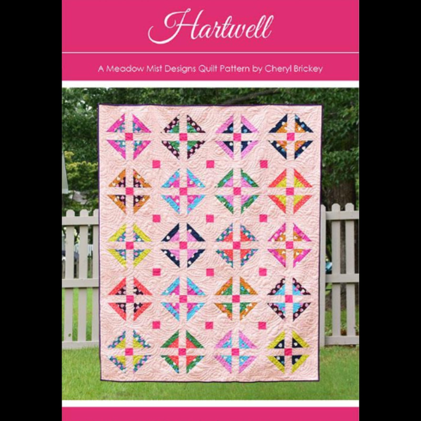 Quilt pattern cover with colorful quilt design on a pink background