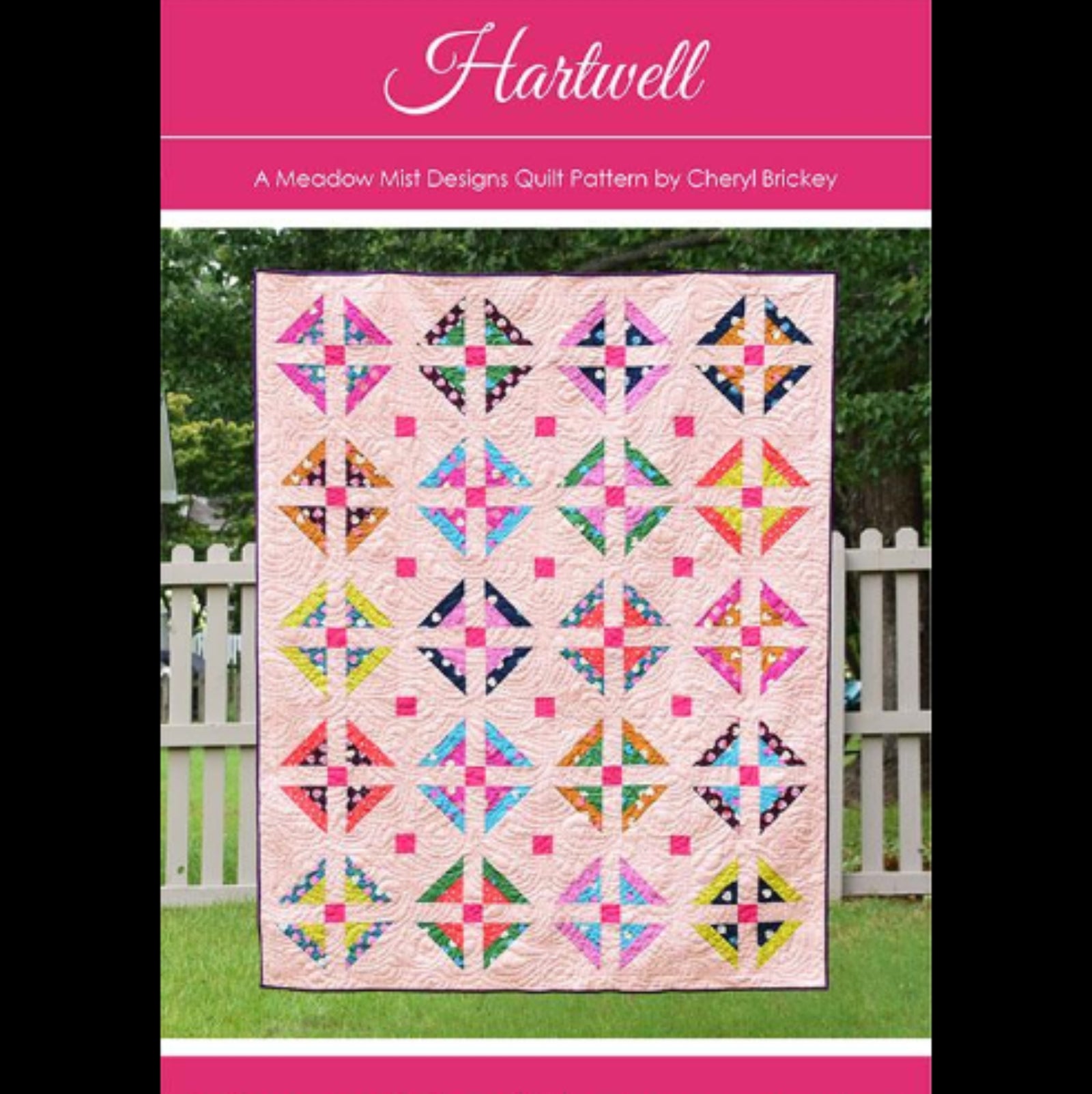 Quilt pattern cover with colorful quilt design on a pink background