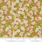 A close-up of a floral fabric pattern with white, orange, and brown flowers on a mustard-yellow background, with a ruler and Modas fabric watermark at the bottom.