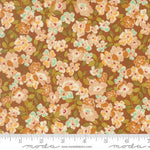A close-up of a floral fabric pattern with orange, cream, and mint green flowers on a brown background, with a ruler and Modas Fabrics watermark along the bottom edge.