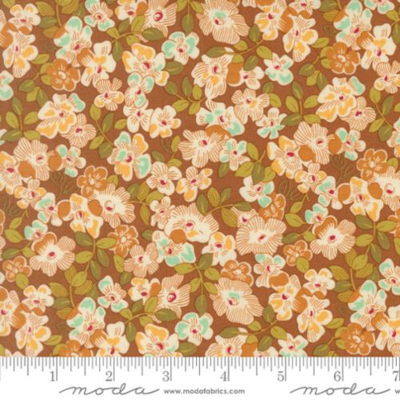 A close-up of a floral fabric pattern with orange, cream, and mint green flowers on a brown background, with a ruler and Modas Fabrics watermark along the bottom edge.
