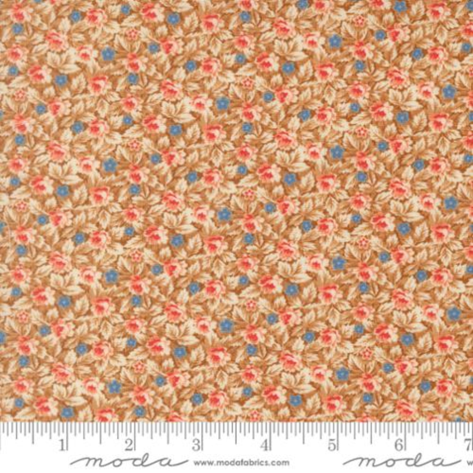 A close-up of a fabric pattern featuring small pink and blue flowers with beige leaves on a warm tan background, with a measuring ruler along the bottom edge showing scale. The brand name 'moda' is visible at the bottom.