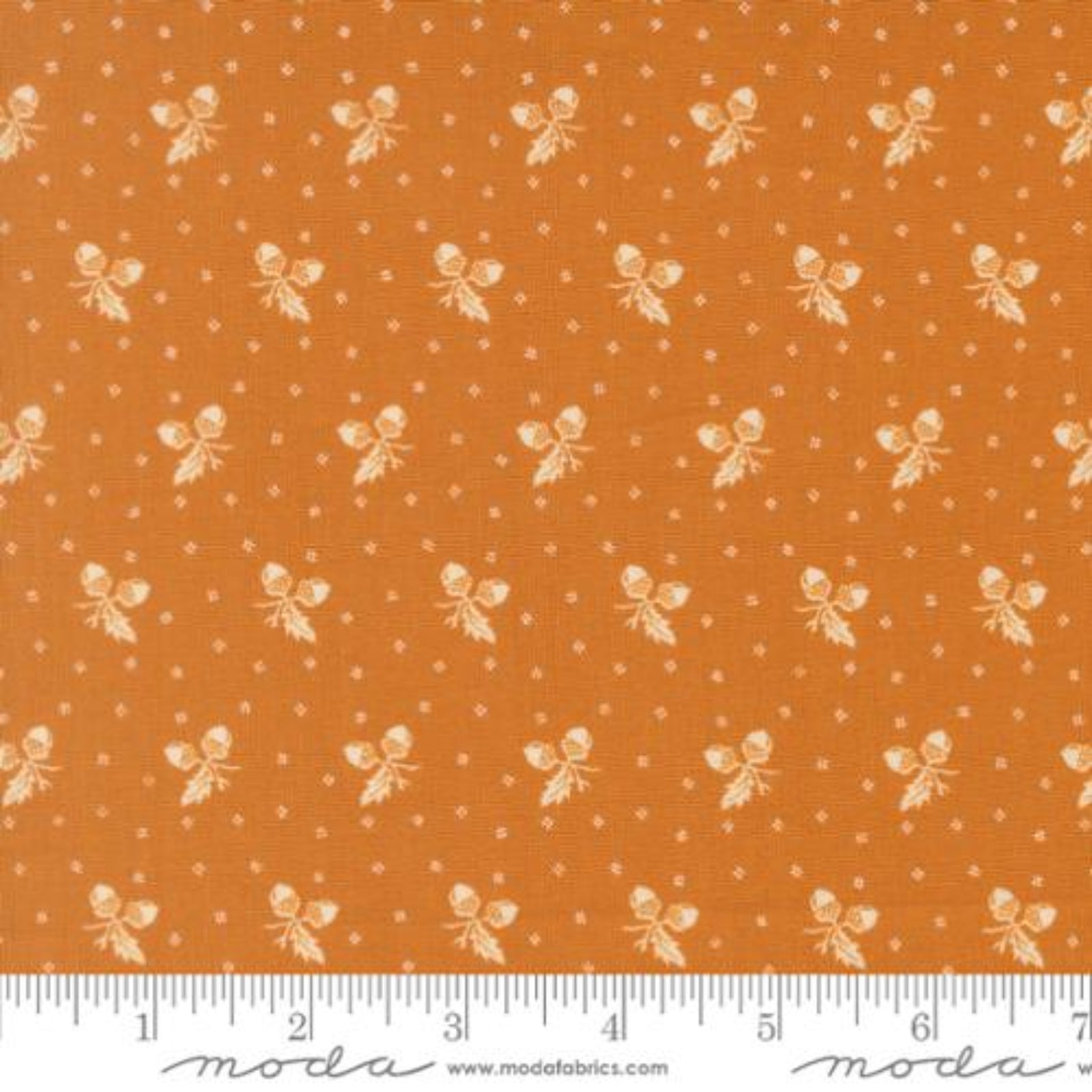 Orange fabric with a repeating cream butterfly and dot pattern, shown flat with a ruler along the bottom edge for scale. The Modas Fabrics watermark is visible at the bottom.