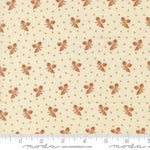 A close-up of a fabric pattern featuring small brown floral motifs and tiny brown dots on a warm cream background, with a ruler along the bottom edge showing scale. The brand name 'Moda Fabrics' is visible at the bottom.